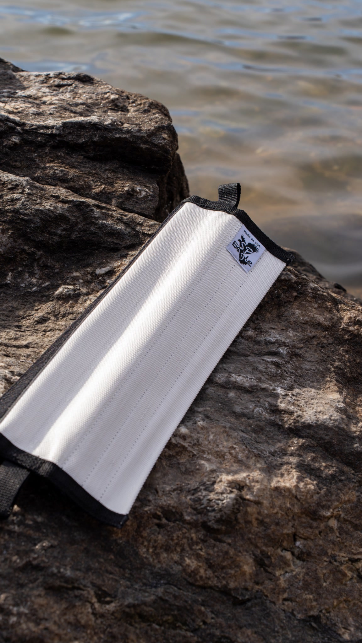 Clean product photograph of the rope protector on rock