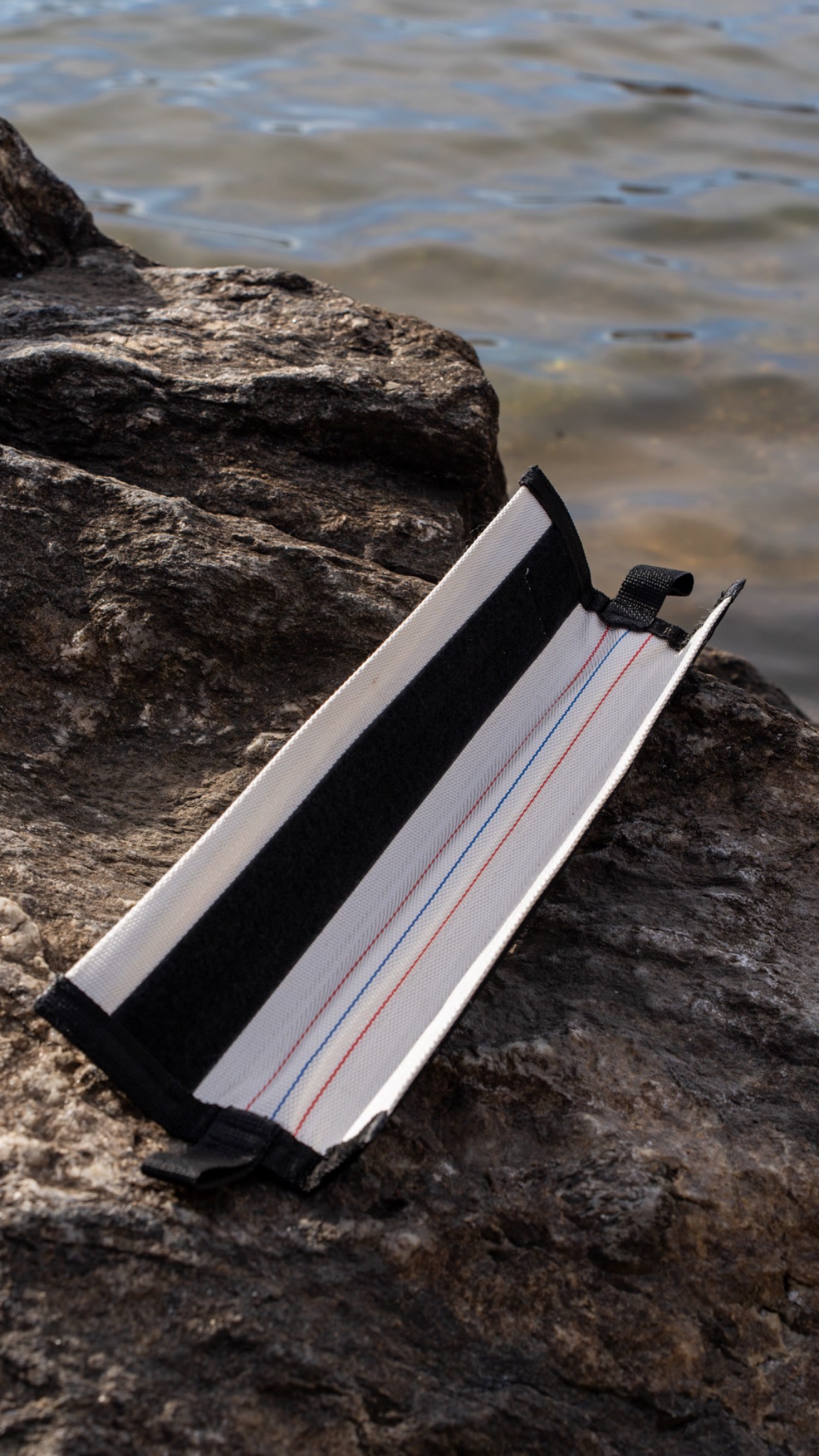 SP Eagle rope protector placed on rough rock near water