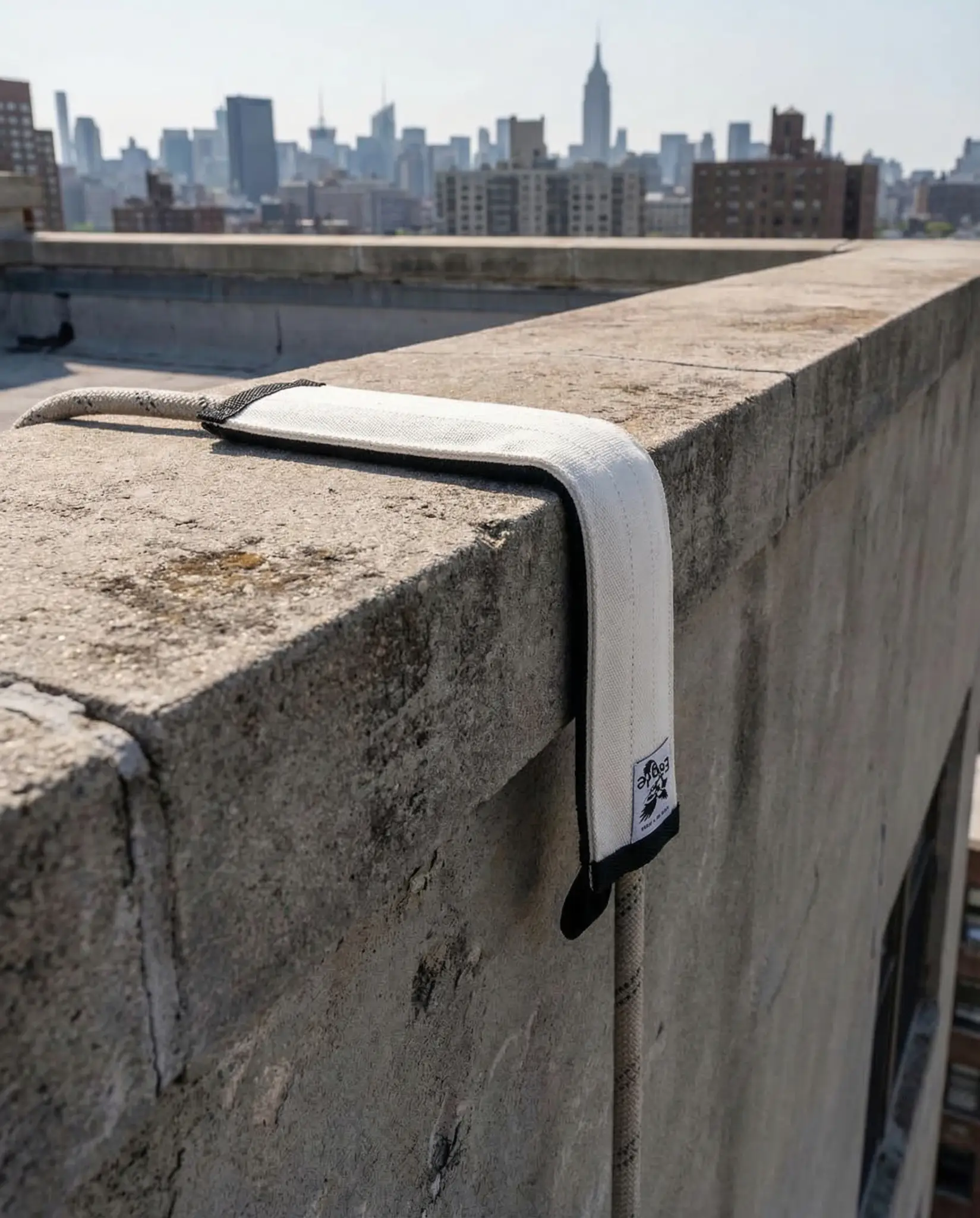 Rope protector hanging over a rooftop concrete edge in New York